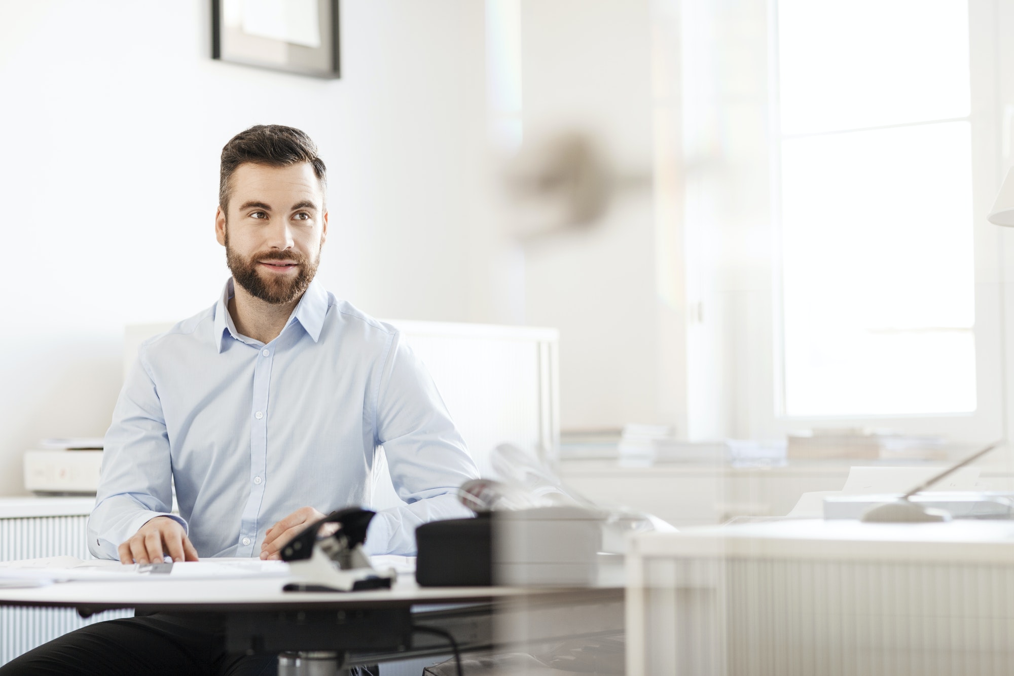 Businessman sitting at a desk in an office.