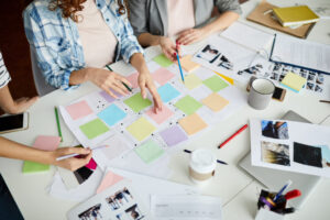 Office team working at desk with post it notes